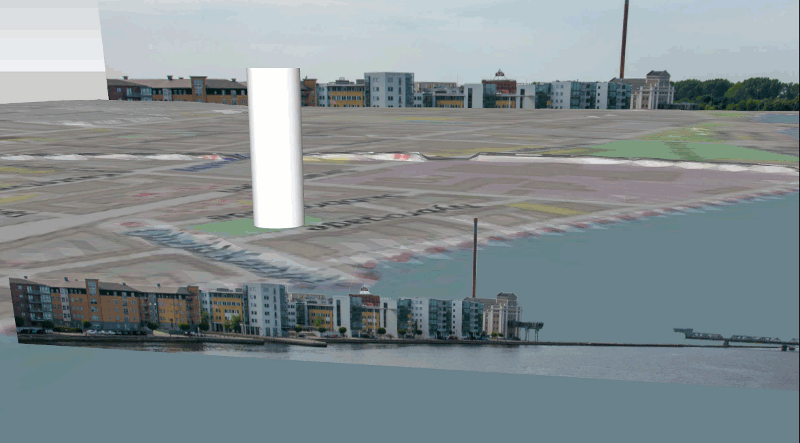 A large white tower in a city

Description automatically generated